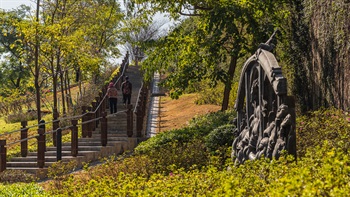 公園內的人工山丘能遮蓋下方的建築物，升高的地勢也造就了設計別出心裁的地貌、小徑及階梯。